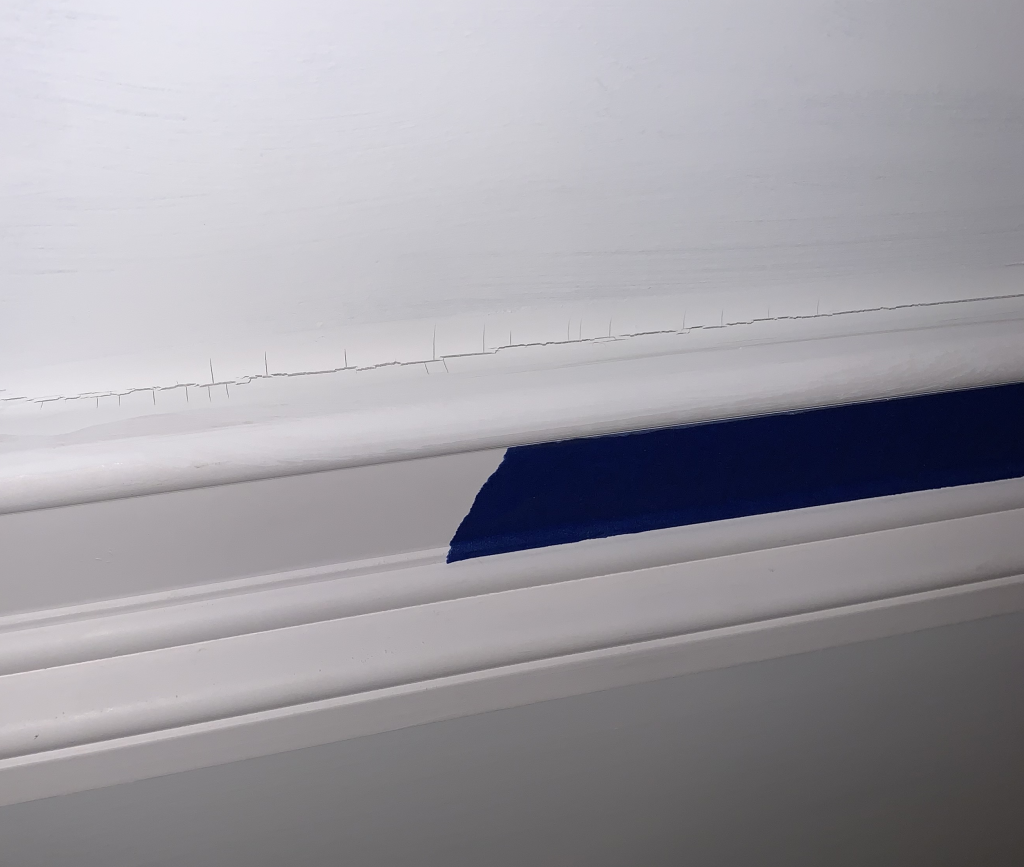 Smooth Tower AU-1 sealant bead along blue painter's tape