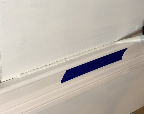 Tower AU-1 sealant bead applied along painter's tape on wall