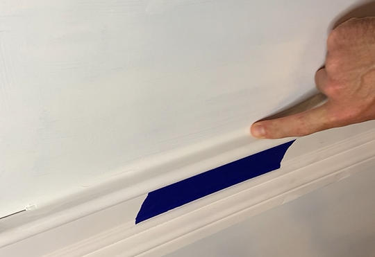 Smooth Tower sealant bead applied along blue painter's tape edge
